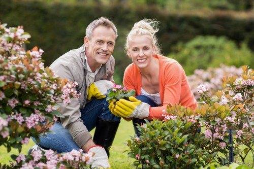 Gardener discussing quote with homeowner in urban garden